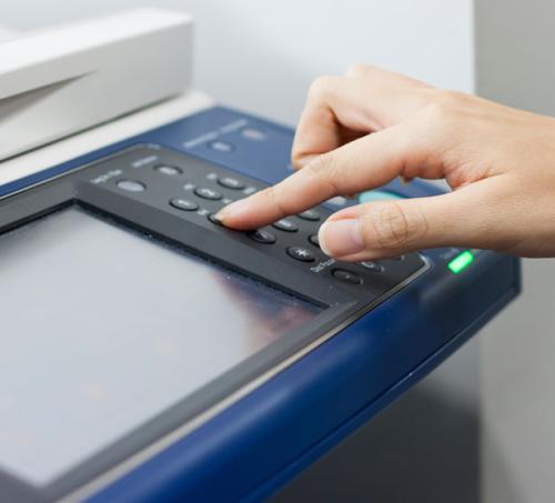 Hand using a fax machine
