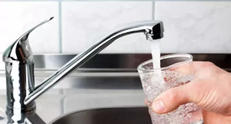 Filling a glass of water under a faucet