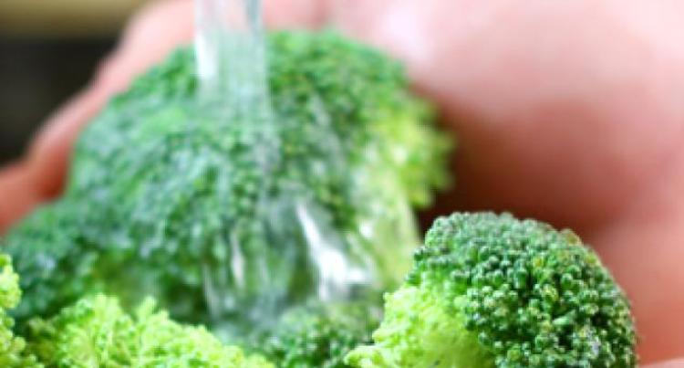 Rinsing Broccolli under water